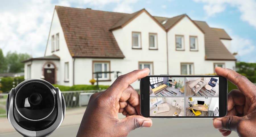 Man holding phone and looking at footage from security cameras